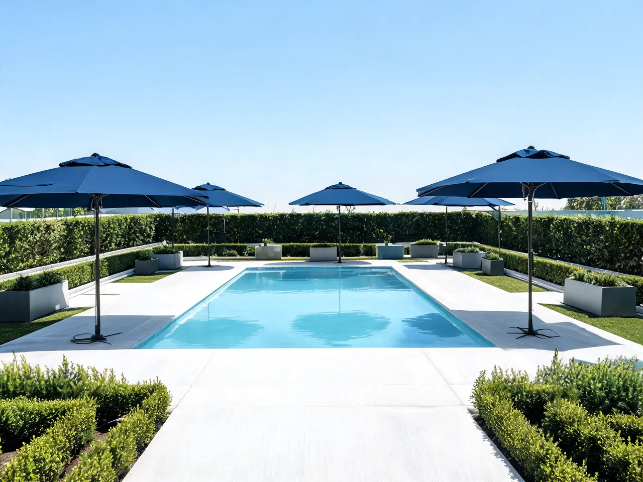 White brushed concrete pool deck idea with a cool-touch coating and navy umbrellas