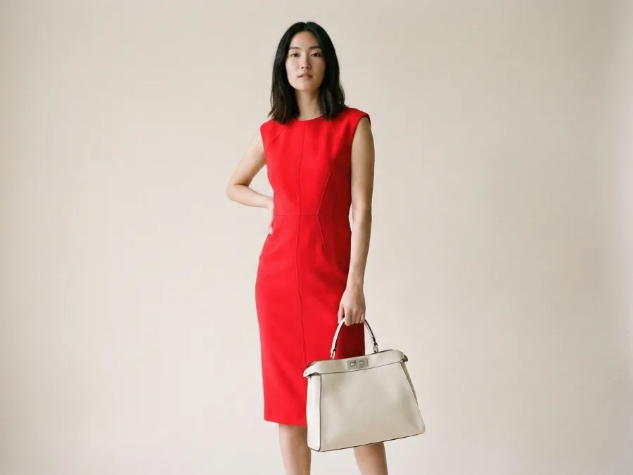 Magazine-style pose restyled with a new dress and a statement bag. after AI redesign