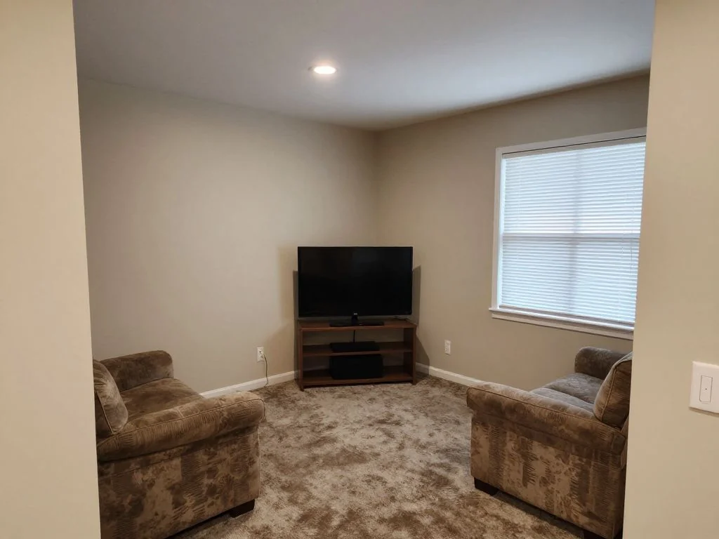 Console corner upgraded with a wall-mounted TV, a media console, and RGB strips. before AI redesign