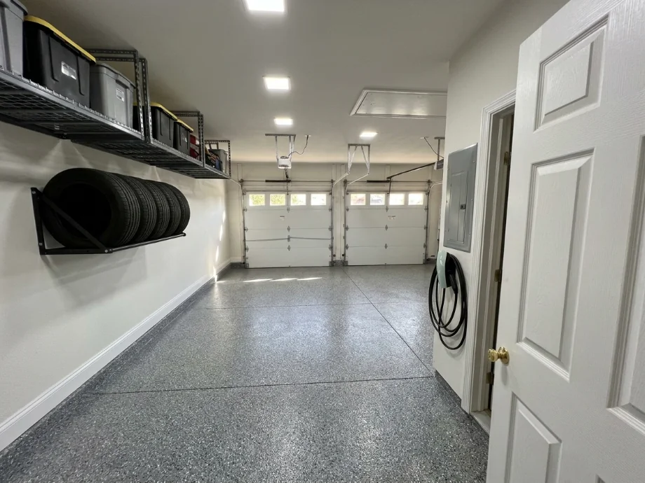Two-car garage upgraded with an EV charger, overhead racks, and a tire rack. after AI redesign
