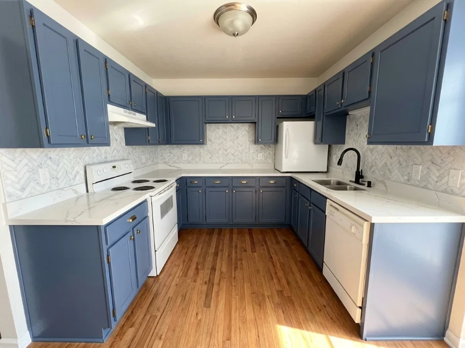 Builder-grade kitchen upgraded with quartz counters and a tile backsplash. after AI redesign