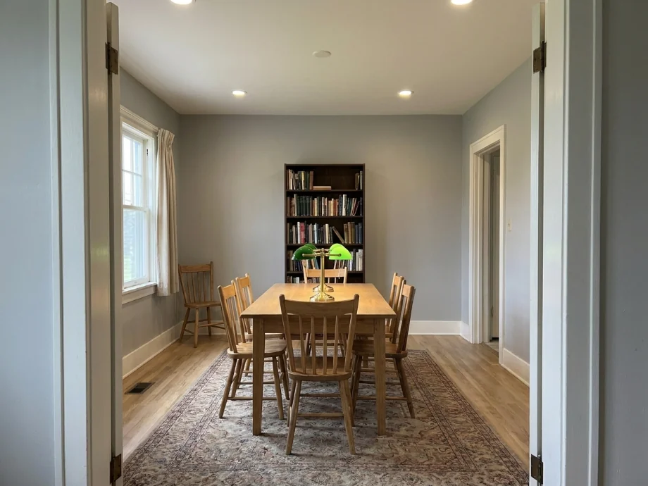 Study library refreshed with a long table, task lamps, and a quieter palette. after AI redesign