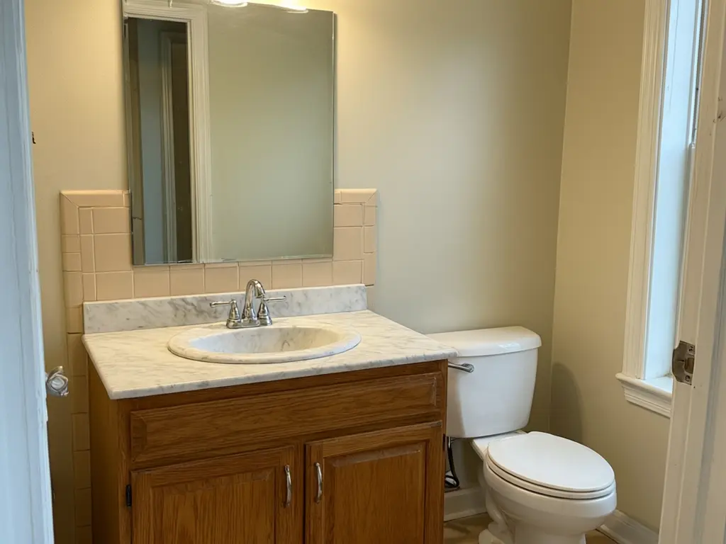 Bathroom vanity visualizer result: dated oak vanity cabinet replaced with a wall-mounted floating vanity in light oak with a white top before AI redesign
