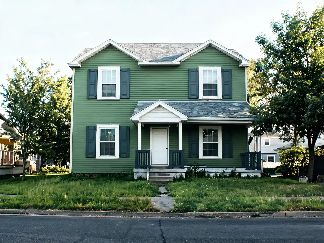 AI house paint visualizer: faded beige siding repainted sage green with white trim after AI redesign