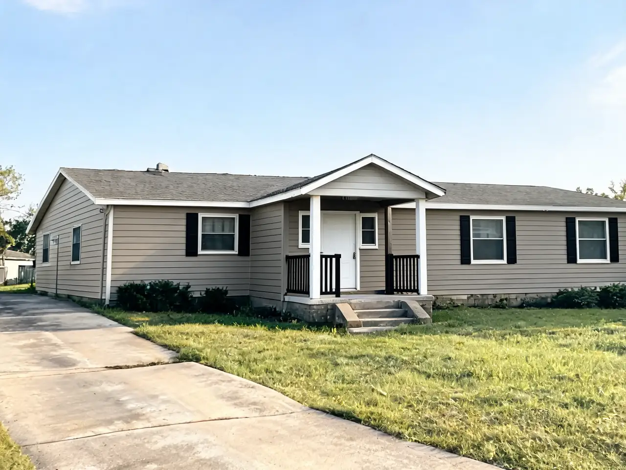 AI exterior paint preview: worn gray ranch house repainted warm greige after AI redesign
