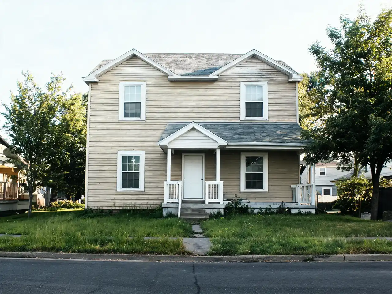 AI house paint visualizer: faded beige siding repainted sage green with white trim before AI redesign