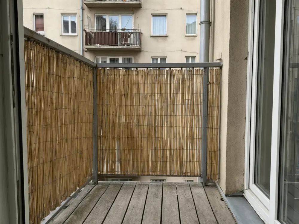 Balcony garden visualizer result: a bamboo privacy screen along a balcony railing after AI redesign