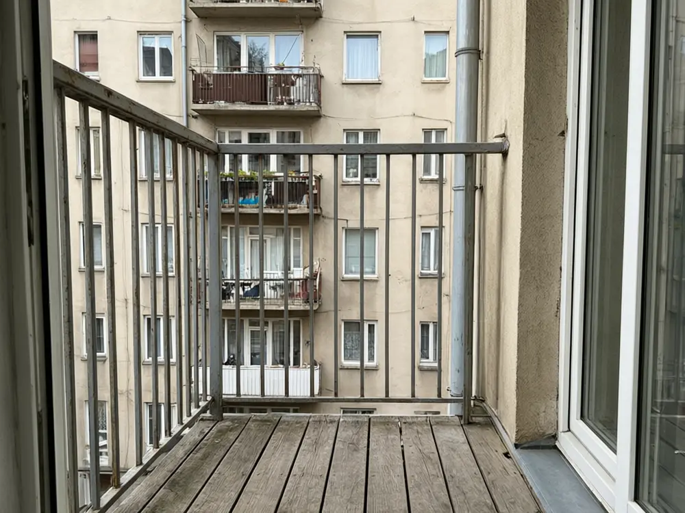 Balcony garden visualizer result: a bamboo privacy screen along a balcony railing before AI redesign