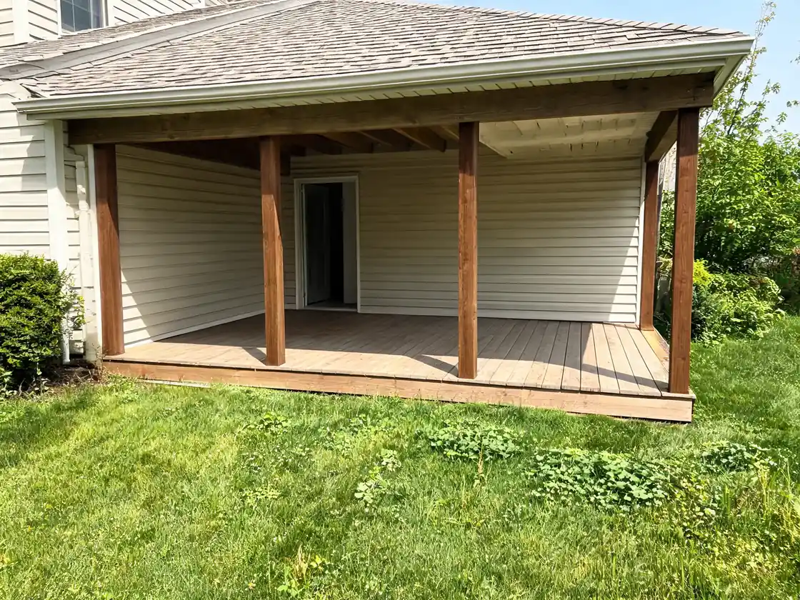 Porch visualizer result: open covered porch converted into a screened-in porch with stained wood framing before AI redesign