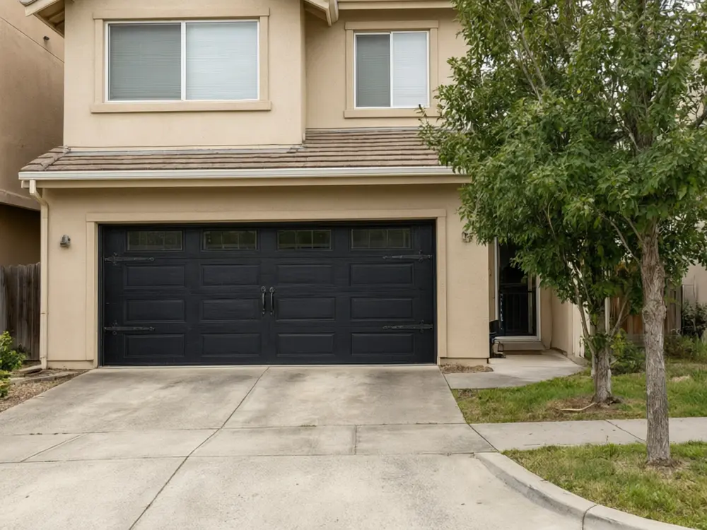 Garage door visualizer result: a black carriage house style garage door after AI redesign