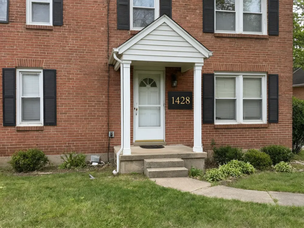 House number sign visualizer result: a brass plaque with the number 1428 beside the door after AI redesign