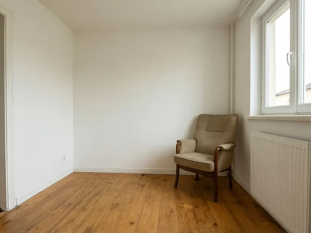 Nursery visualizer result: a bedroom with soft sage green walls before AI redesign