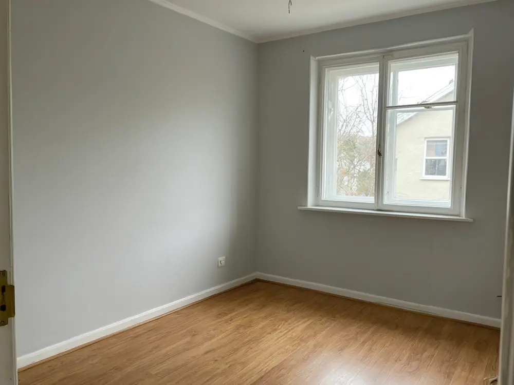 Nursery visualizer result: a nursery with a sage board and batten accent wall before AI redesign