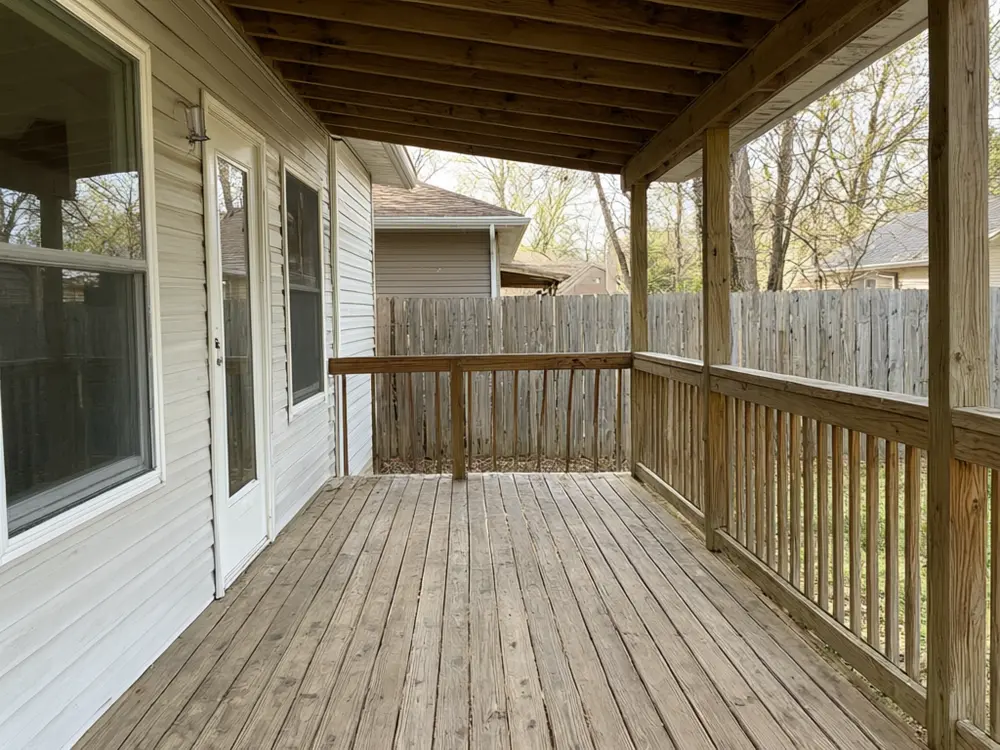 Outdoor kitchen visualizer result: an L-shaped outdoor kitchen on a covered deck before AI redesign