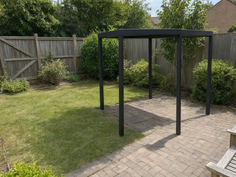 Patio cover visualizer result: a freestanding black flat roof cover over a backyard seating area after AI redesign