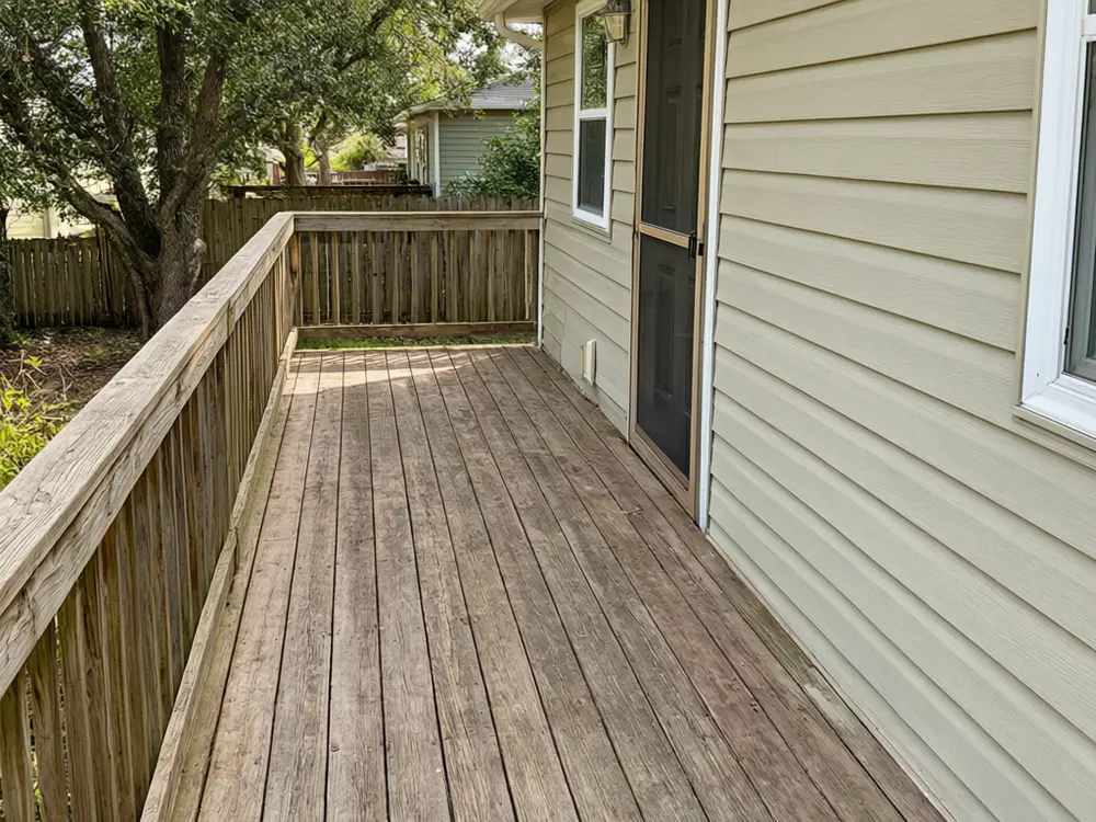 Patio cover visualizer result: a white solid roof patio cover on charcoal posts over a back deck before AI redesign