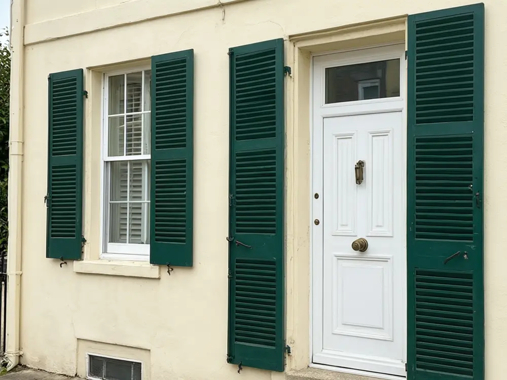 Shutter visualizer result: navy shutters on a cream coloured house before AI redesign