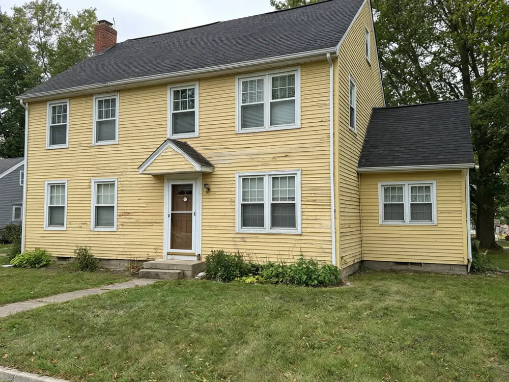 Siding visualizer result: a house with new sage green board and batten siding before AI redesign