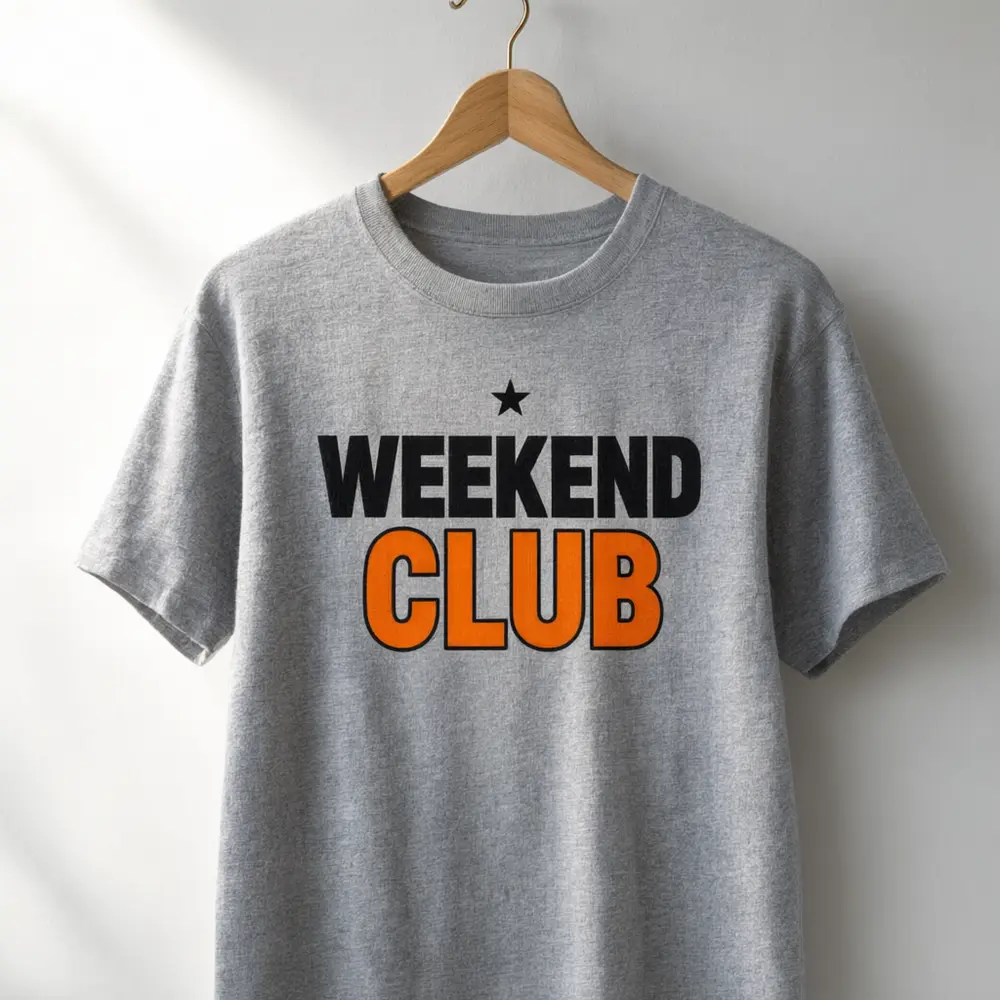 T-shirt mockup result: lettering slogan on a heather grey t-shirt hanging on a wooden hanger after AI redesign