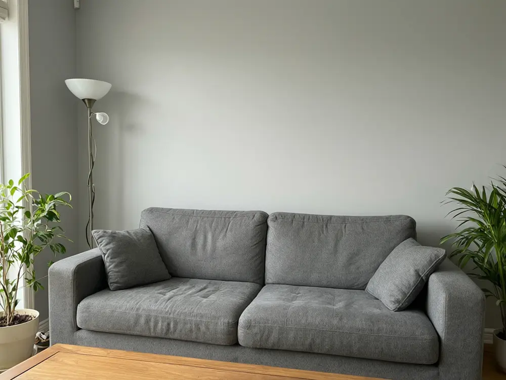 Wallpaper visualizer result: a navy and white striped accent wall behind a sofa before AI redesign